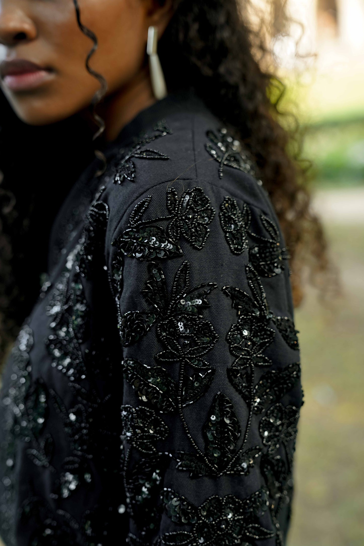Detail picture of the sleeve on Black hand-embroidered bomber jacket