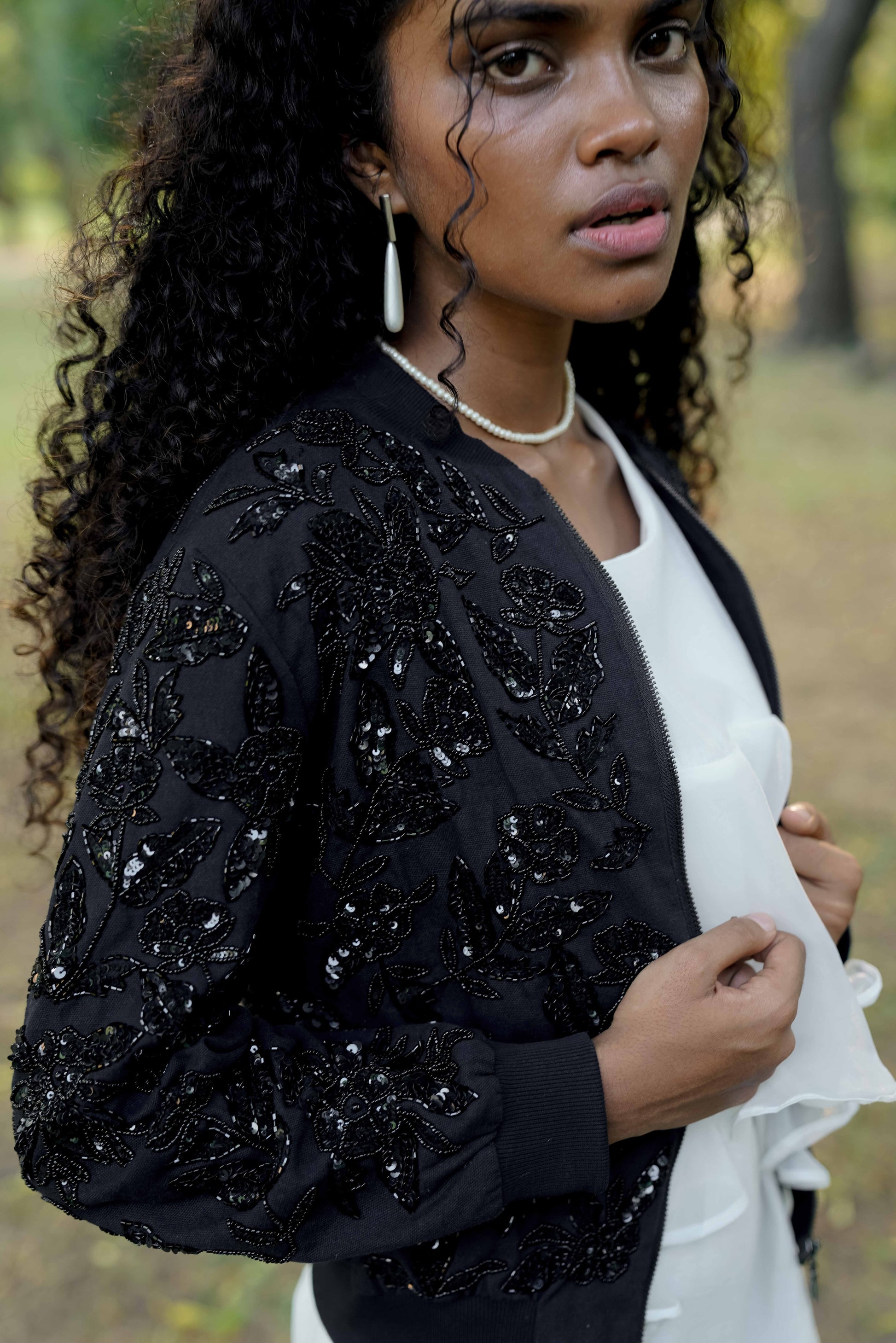 Side detail picture of Black hand-embroidered bomber jacket