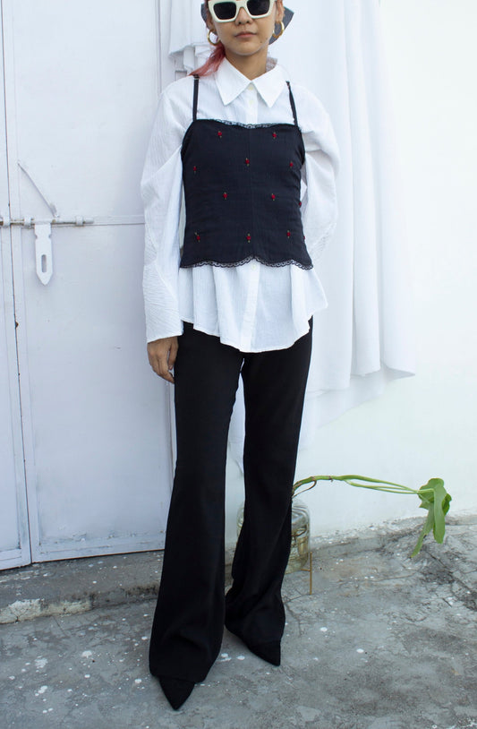 Full front picture of black embroidered camisole with bottom styling option