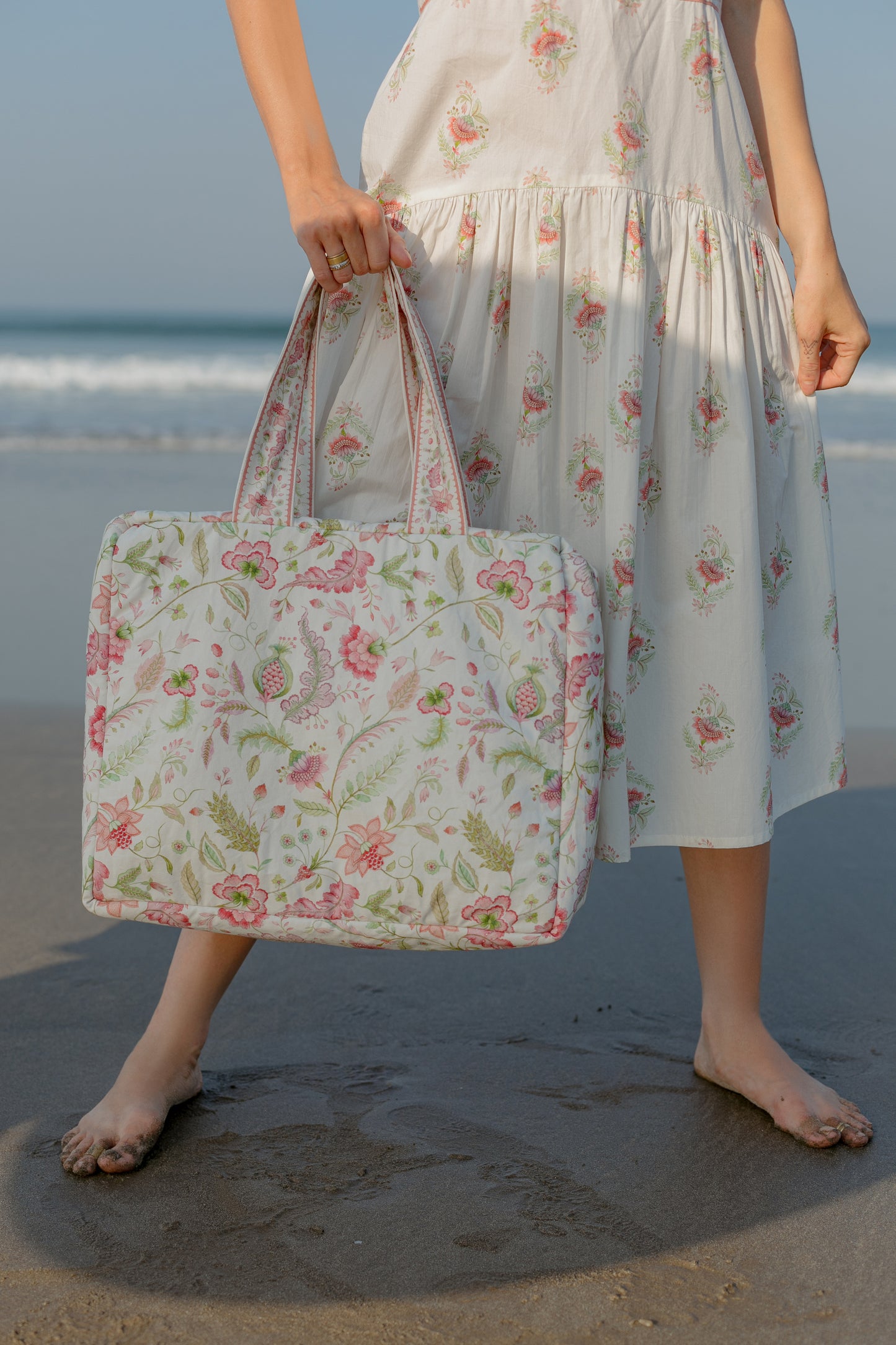 Front picture of model carrying Pink floral tote bag