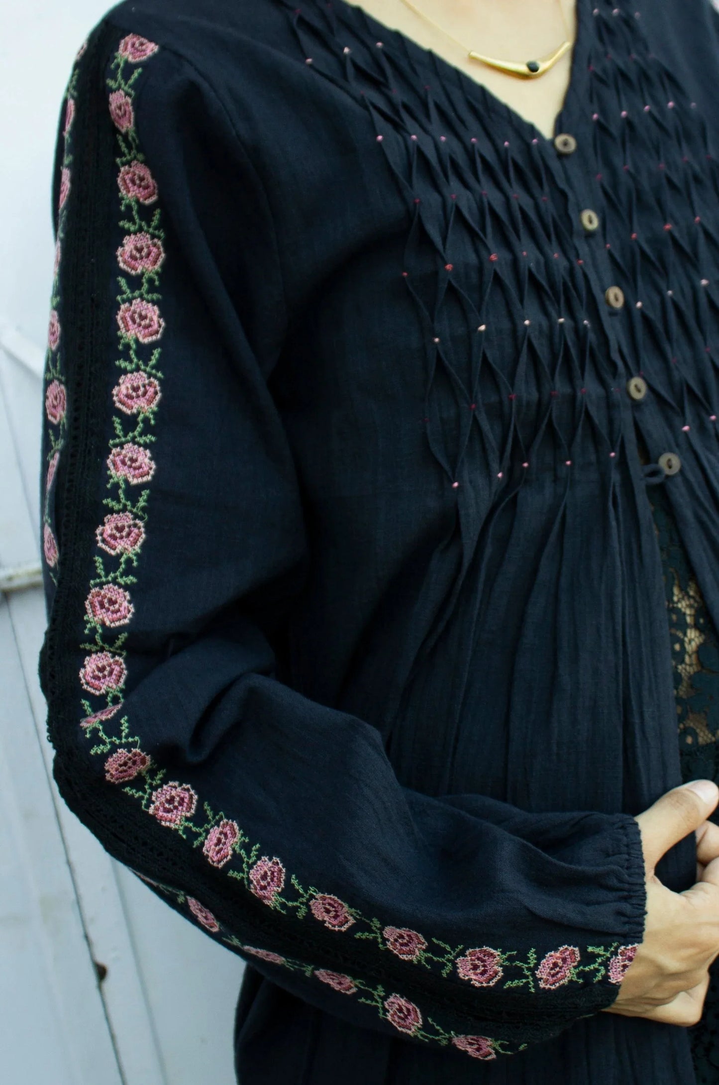 Detail picture of black embroidered long sleeve cotton top showing long sleeves and embroidery detail