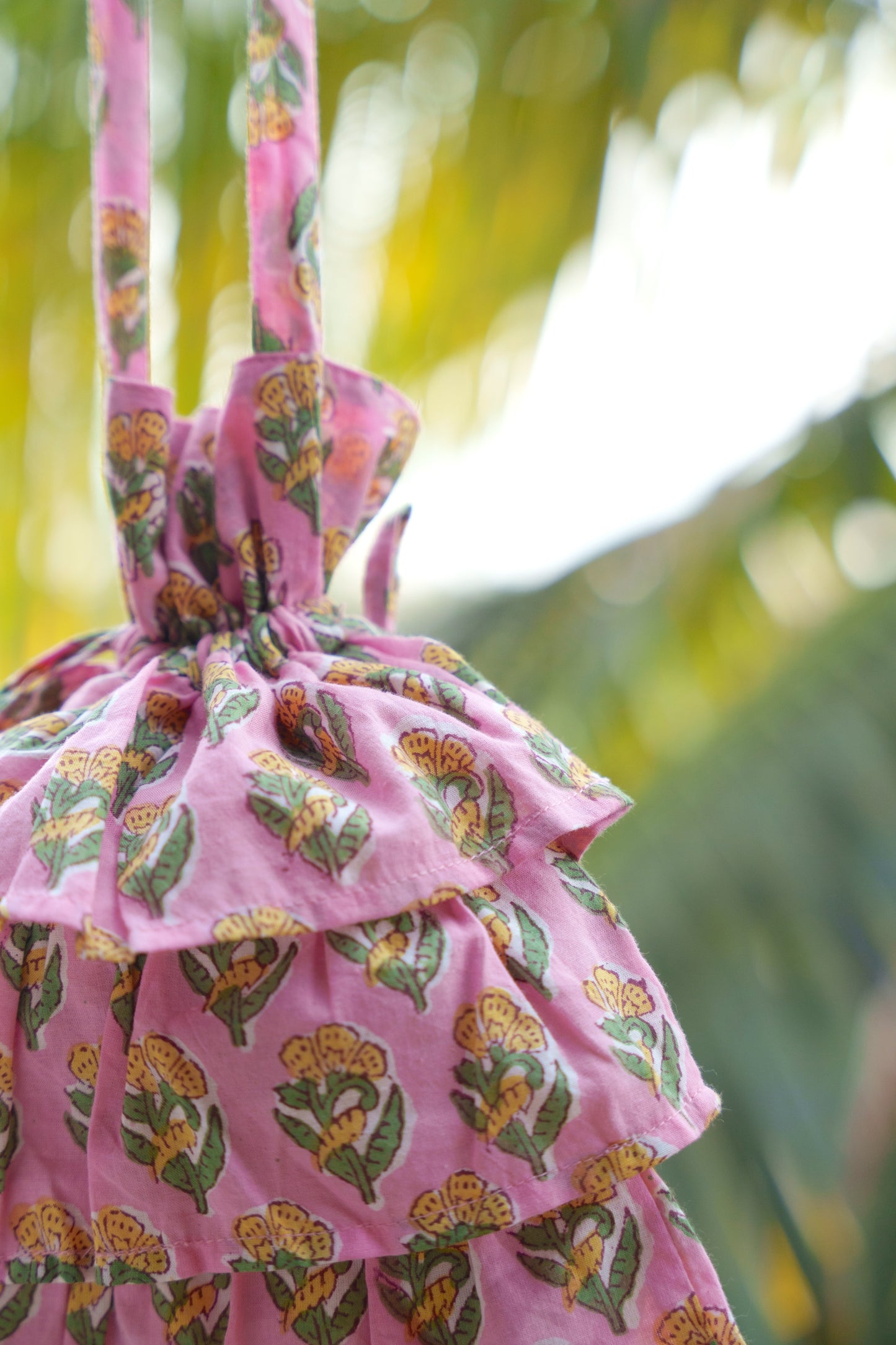 close up picture of pink frill bag with yellow flowers