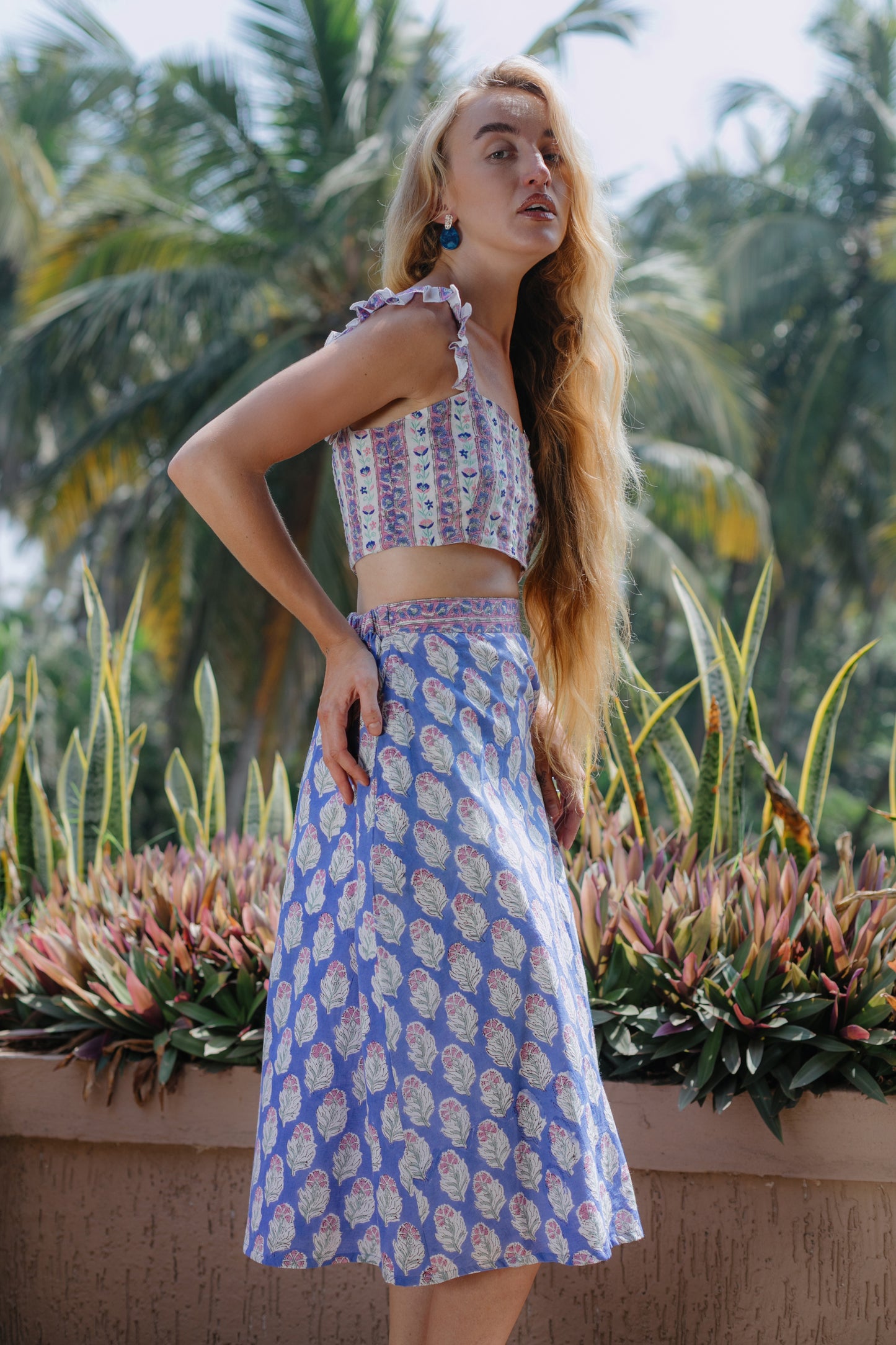 Side image of purple crop top and skirt set