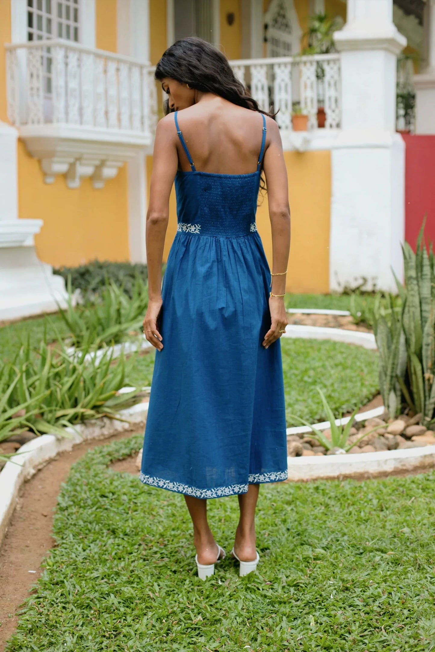 Back view of royal blue embroidered cotton midi dress showing elasticated back and adjustable straps — Amaya World