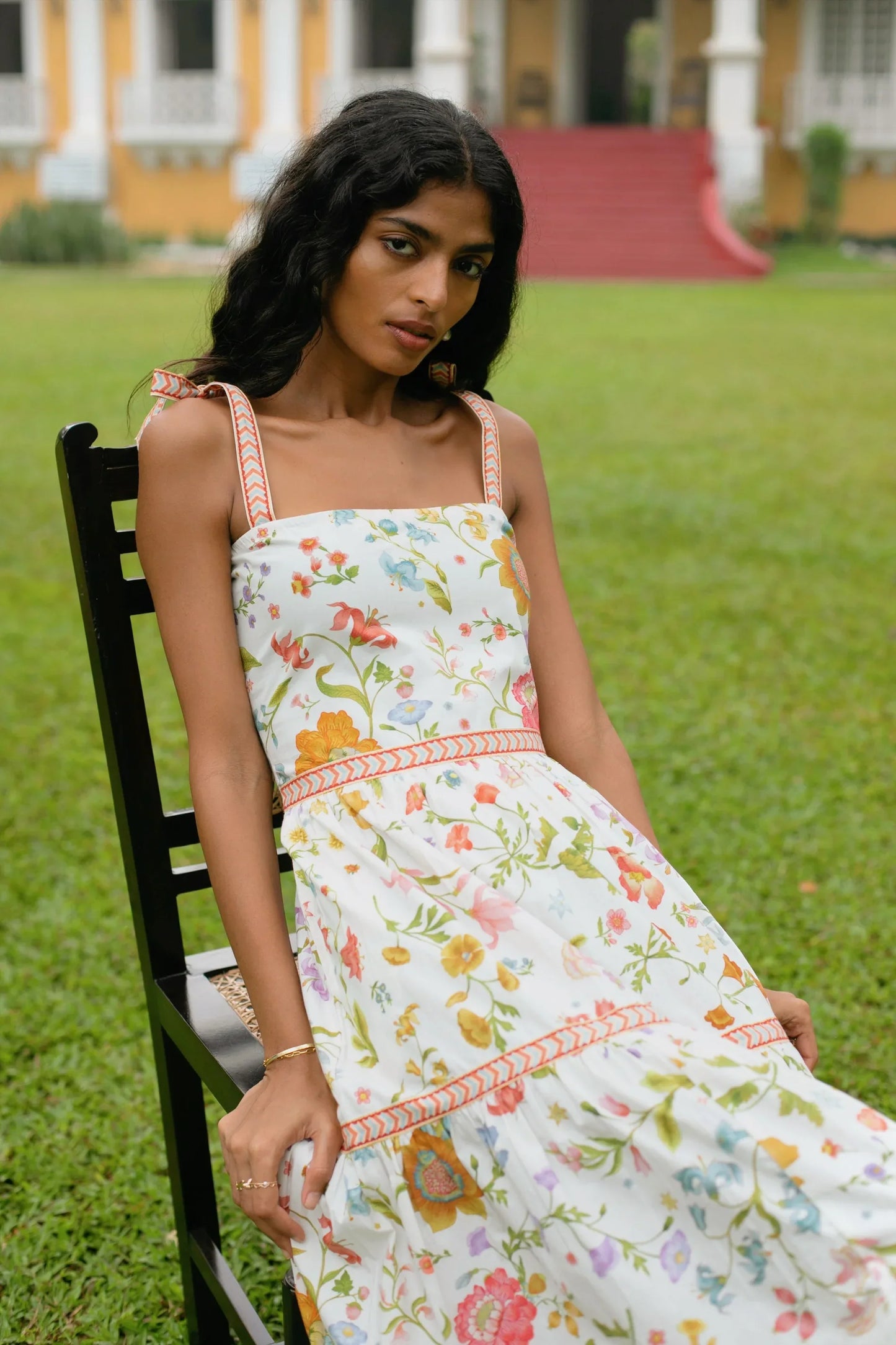 Close-up view of white floral tiered cotton maxi sundress with tie-up straps and A-line silhouette showing print and strap detail— Amaya World