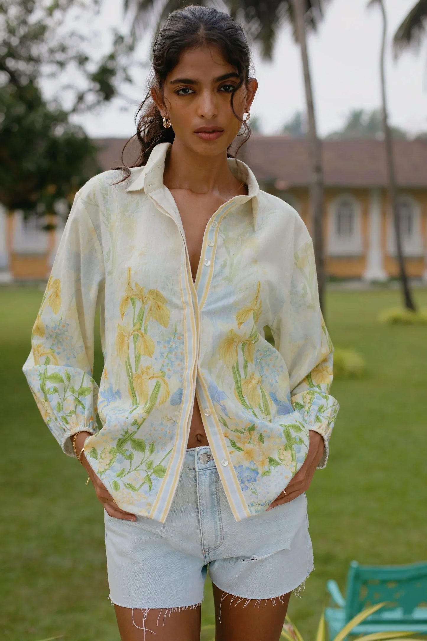 Close-up of mother-of-pearl buttons and puff sleeve cuff on yellow floral cotton linen shirt — Amaya World
