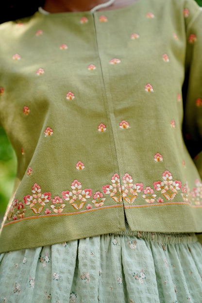 Detail picture of hemline of sage green embroidered jacket