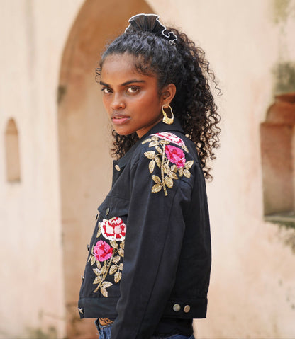 Side picture of black embroidered denim jacket