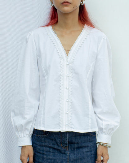 Front photo of white puff sleeve blouse with lace trim detail