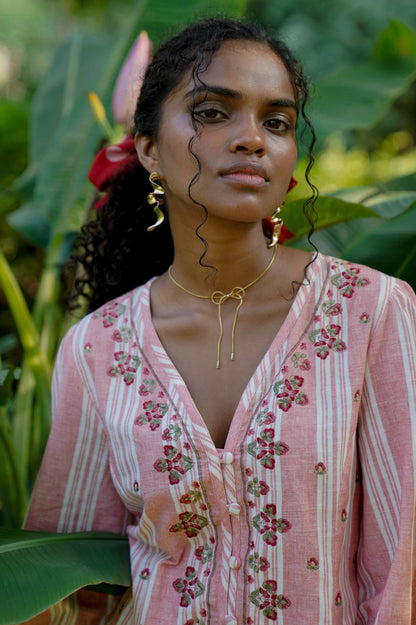 Neckline detail picture pink embroidered blouse with puff sleeves