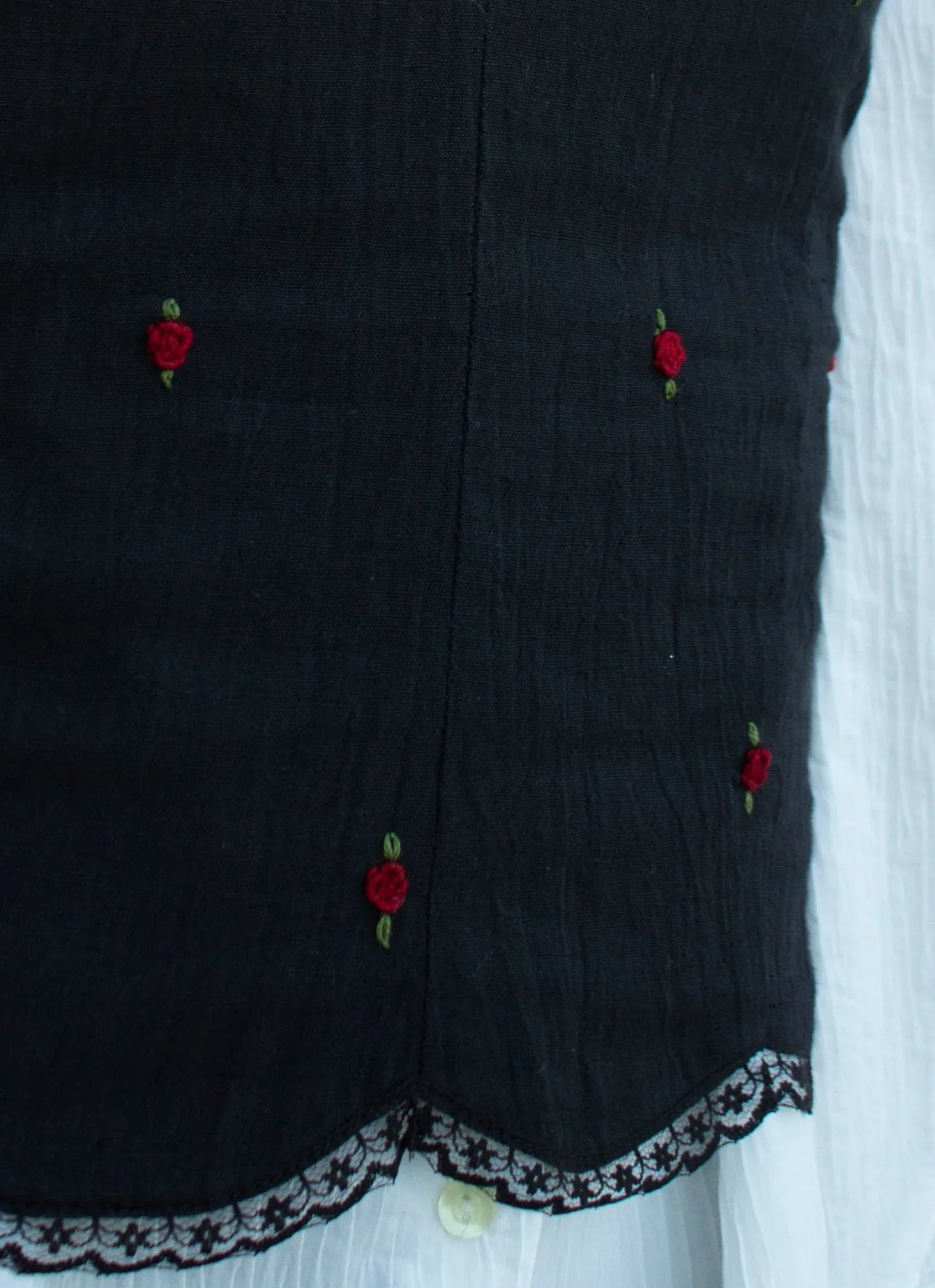 Detail picture black embroidered camisole showing red rose embroidery and scallop hem with lace detail 02