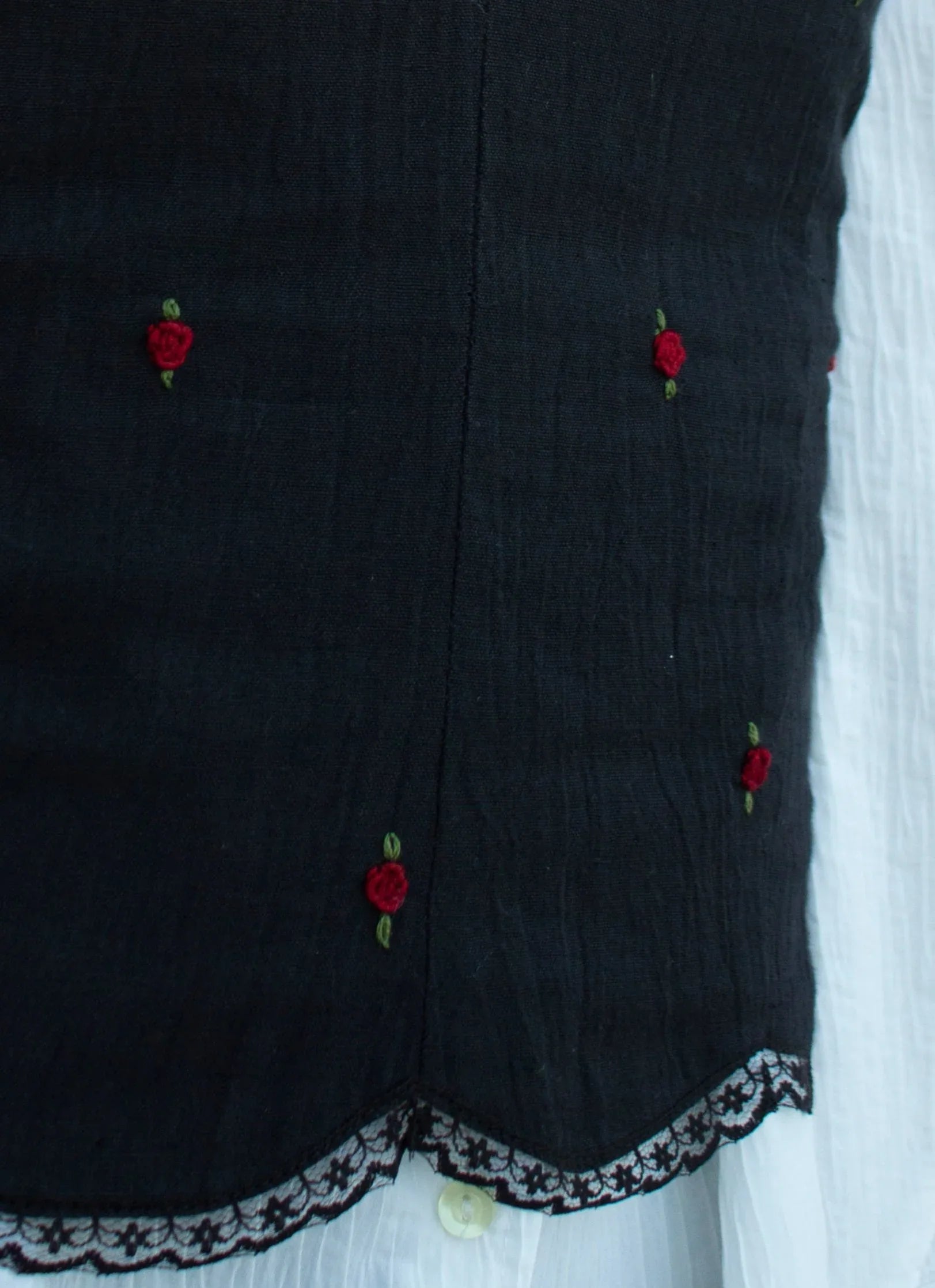 Detail picture black embroidered camisole showing red rose embroidery and scallop hem with lace detail 02