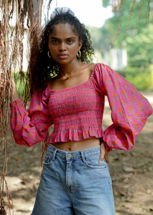 Front picture of pink floral long sleeve crop top in 100% cotton styled with shorts