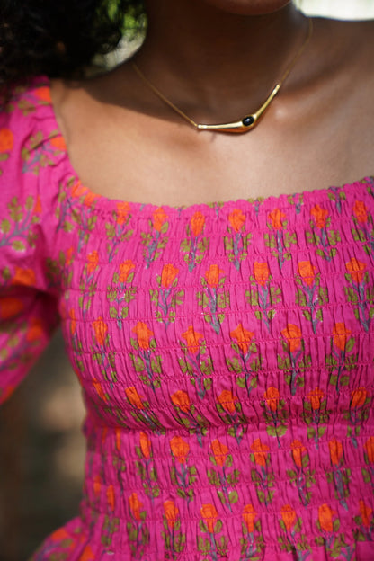 close up detail picture of pink floral long sleeve crop top in 100% cotton