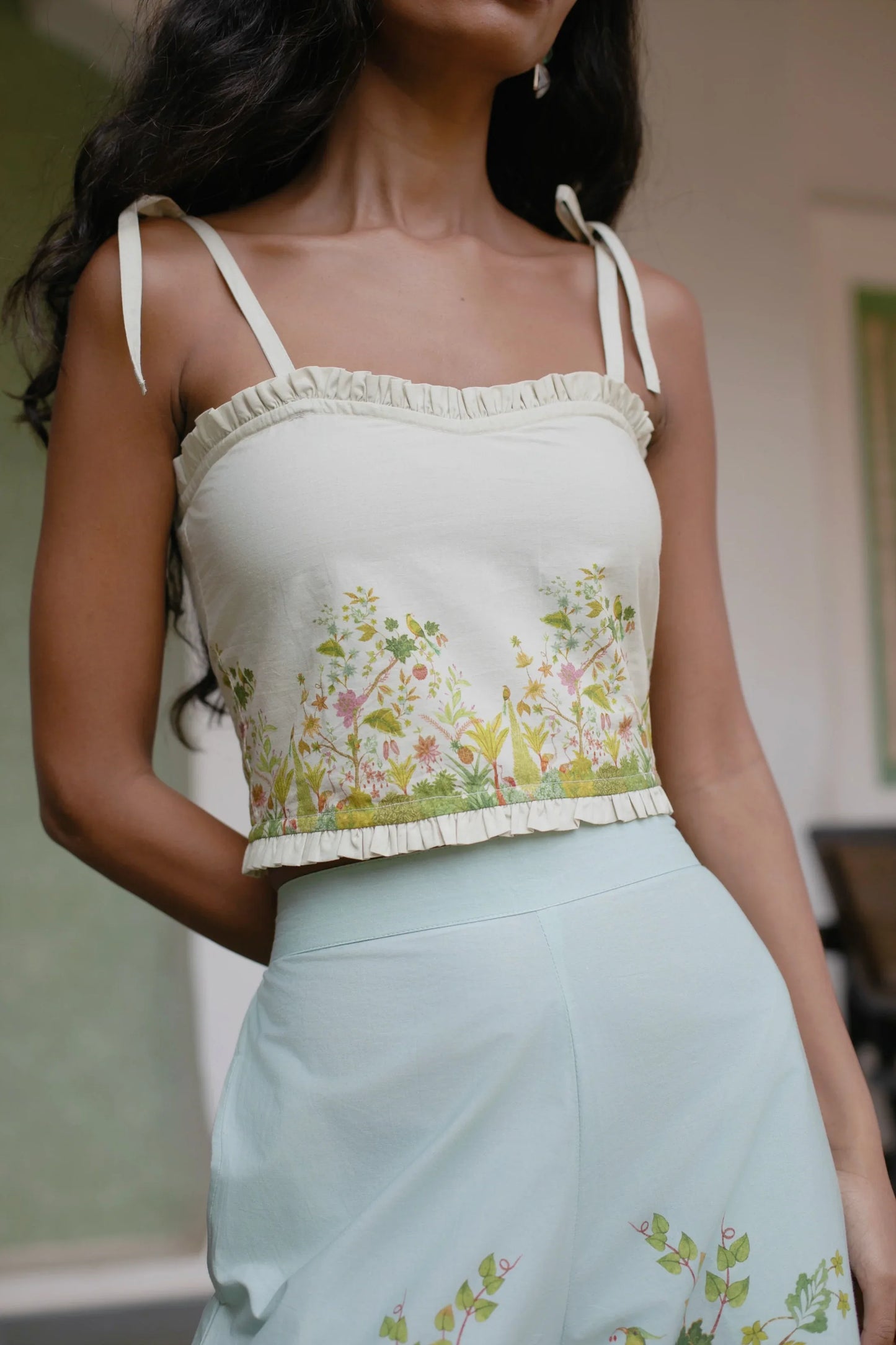 Close-up image of Off white botanical Chintz print cotton crop top with sweetheart neckline and tie-up straps — Amaya World