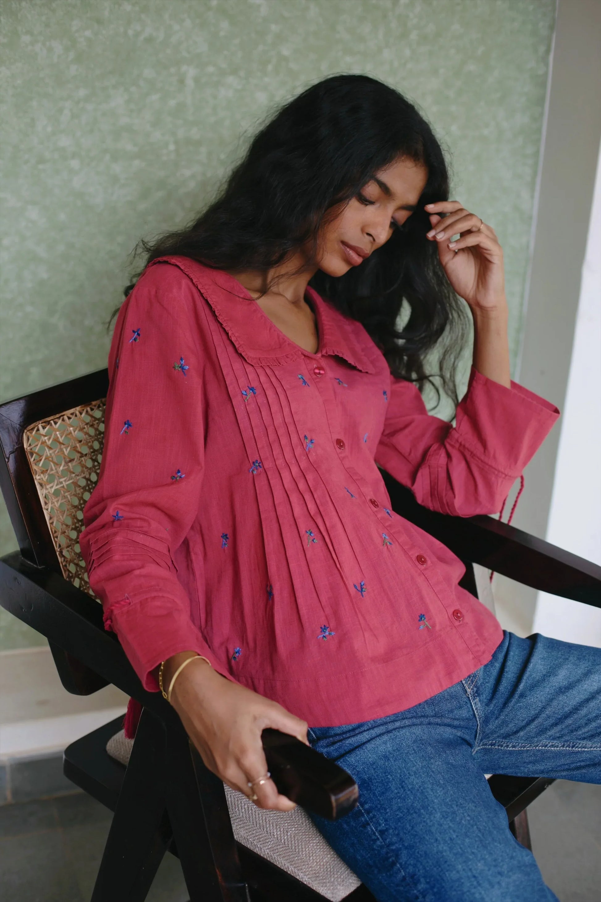 Side view of Red red hand-embroidered cotton linen boho blouse with midnight blue floral motifs— Amaya World