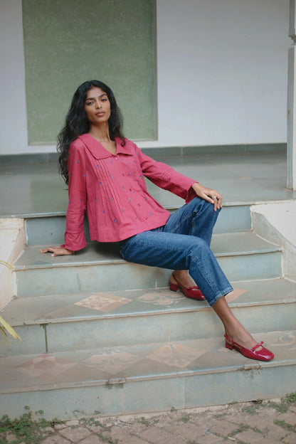 Red embroidered cotton linen boho blouse with oversized collar and tassel on sleeves styled with blue jeans— Amaya World