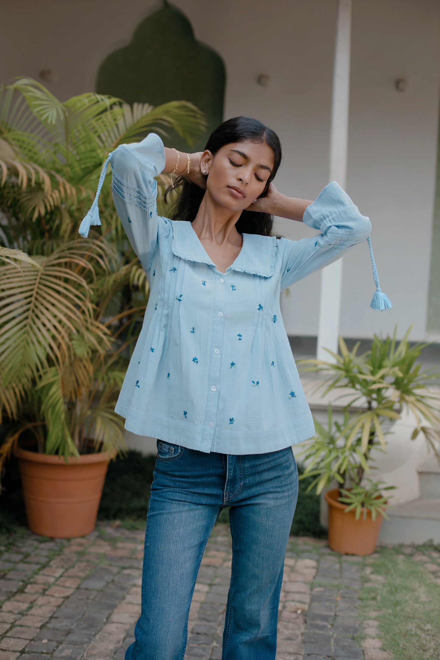 Light blue embroidered cotton linen boho blouse with peter pan oversized collar and tassel on sleeves - Close up| Amaya World