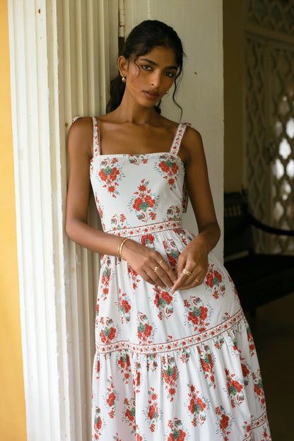 Close-up view of white hand-painted Floral print tiered cotton poplin maxi dress with fit and flare silhouette and straps— Amaya World