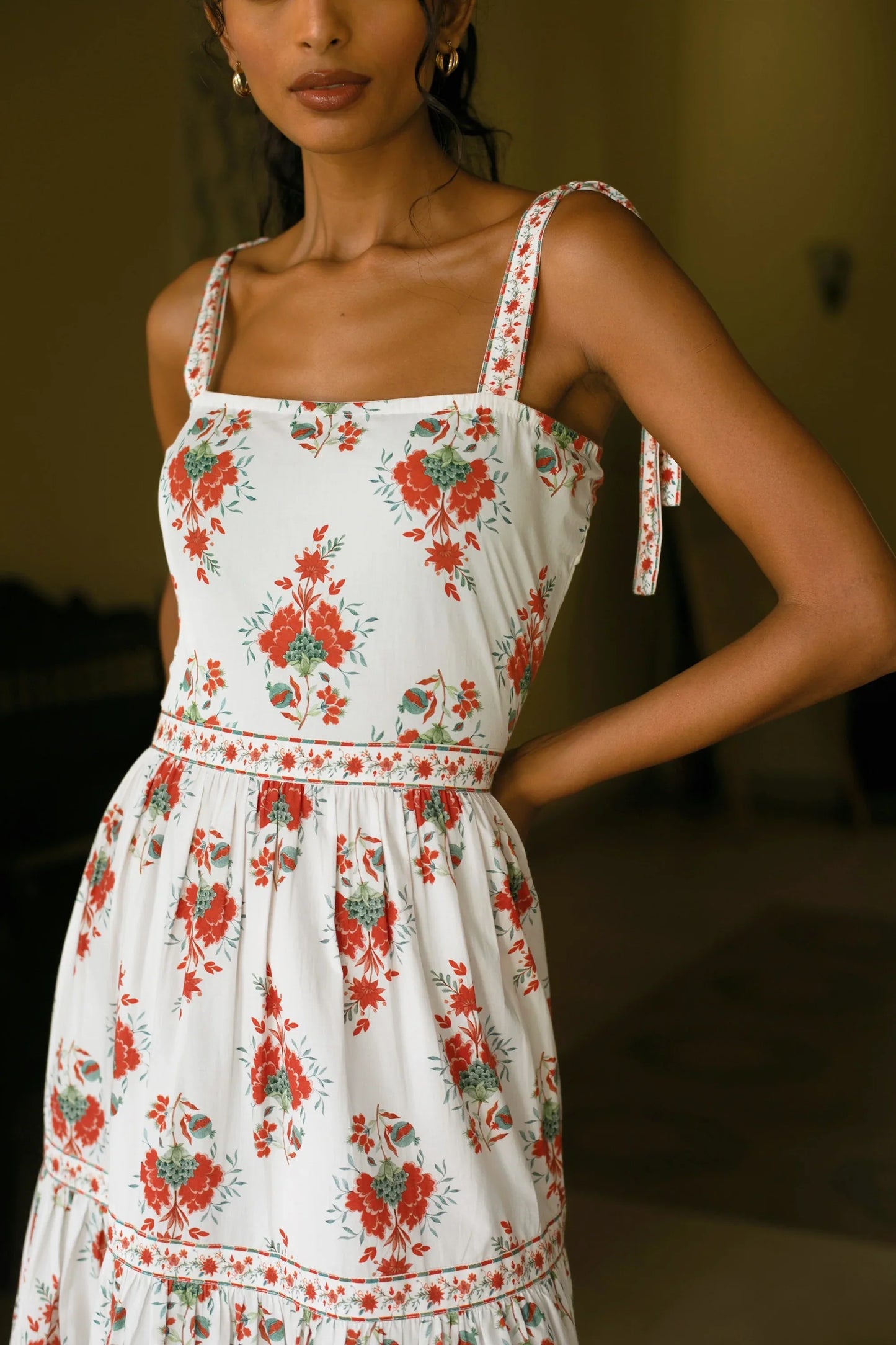 Close-up view of hand-painted Chintz botanical print on red white tiered cotton maxi sundress showing neckline and strap detail— Amaya World