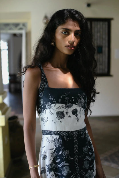 Close-up of hand-painted Chintz geometric floral motifs on black white cotton linen maxi dress showcasing tie-up straps and square neckline— Amaya World