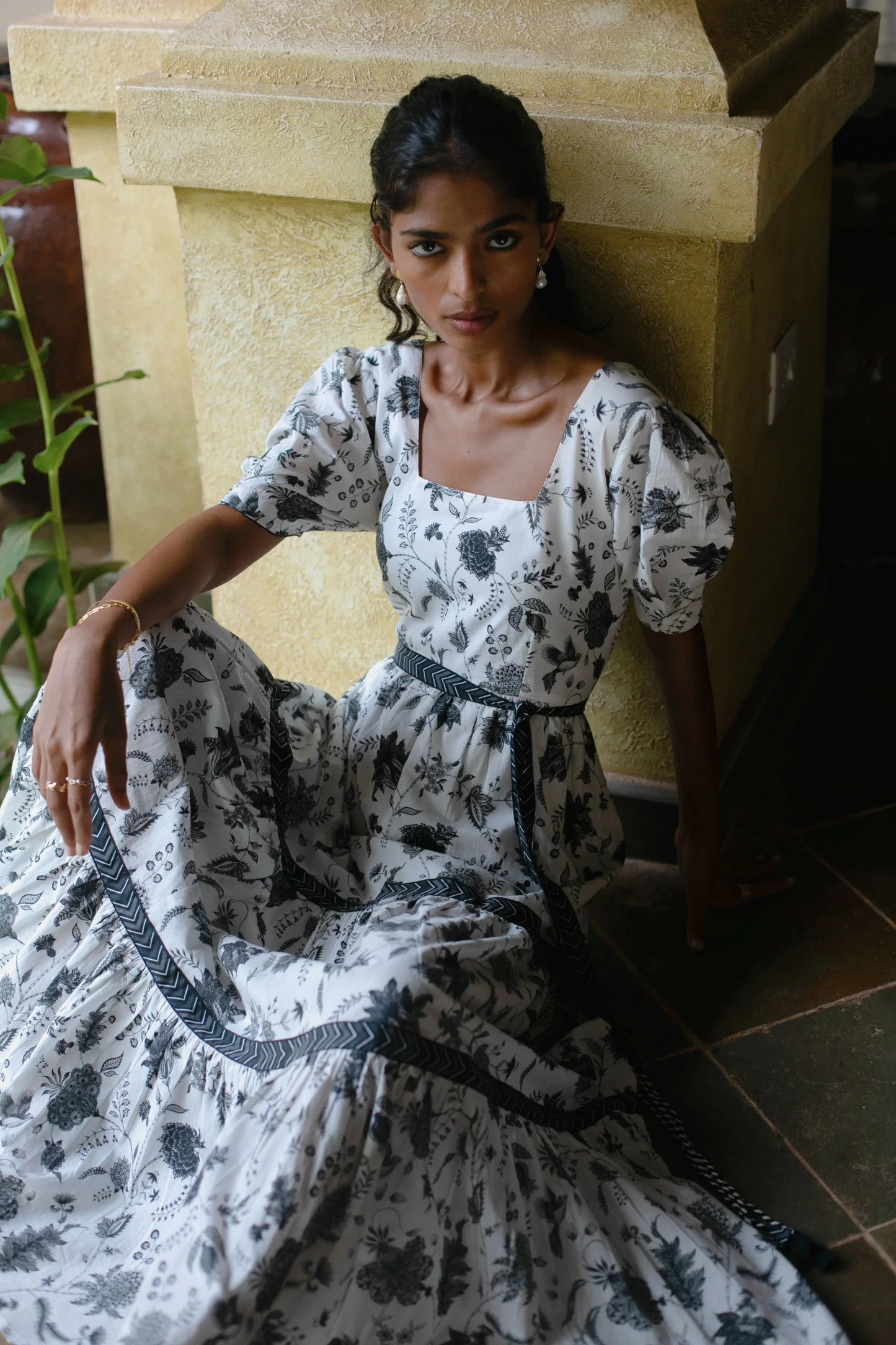 Close-up of floral Chintz print white maxi dress with square neckline, puff sleeves and boho style tiered silhouette  — Amaya World