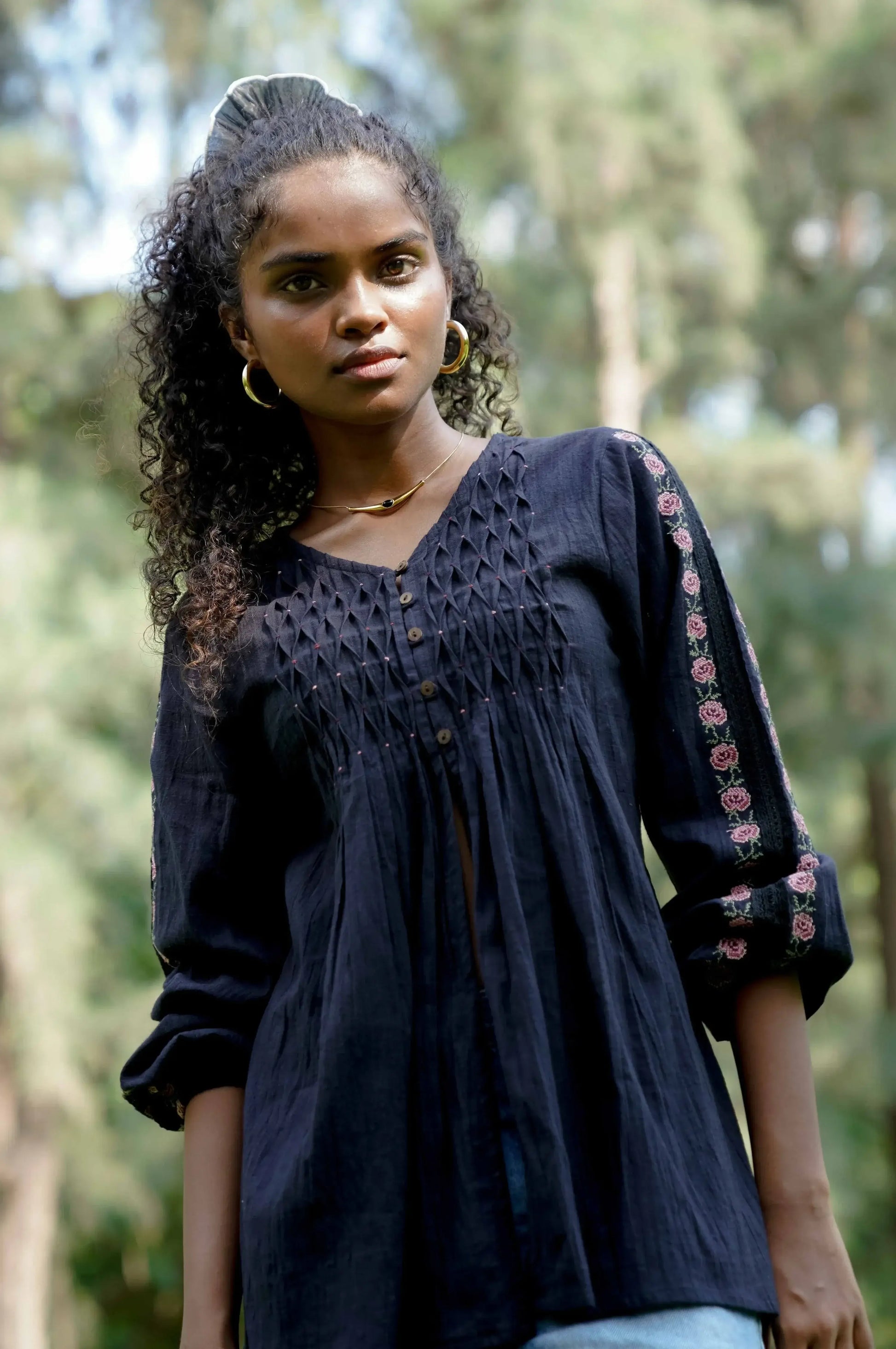 Close up picture of black embroidered long sleeve cotton top 