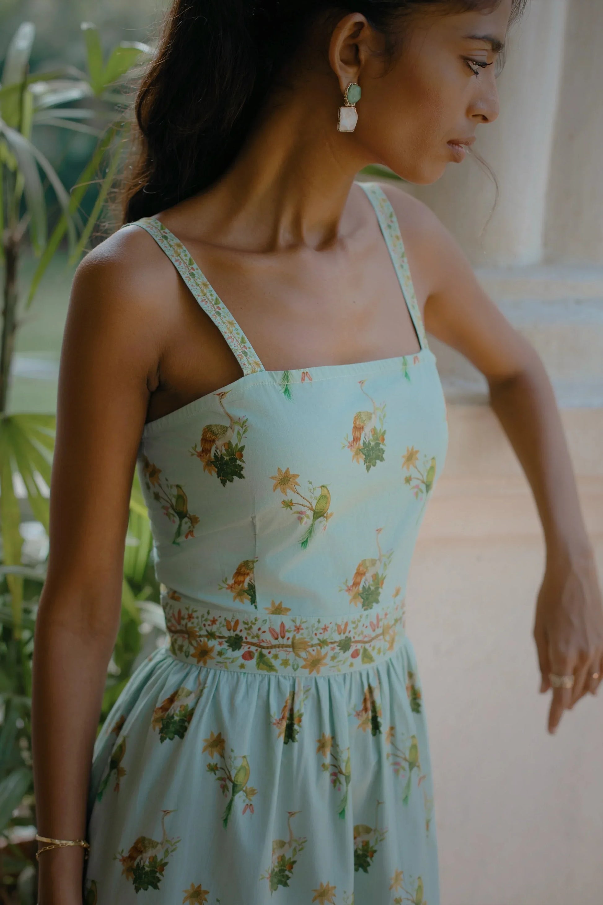 Close-up showing the hand-painted botanical print on blue cotton fit-and-flare midi dress — Amaya World