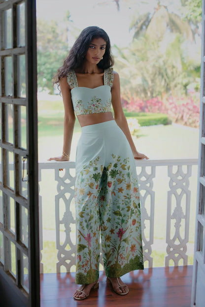 Front view of Blue Floral Chintz inspired botanical print high-waisted wide-leg cotton trousers styled with blue floral bralet crop top— Amaya World handmade slow fashion