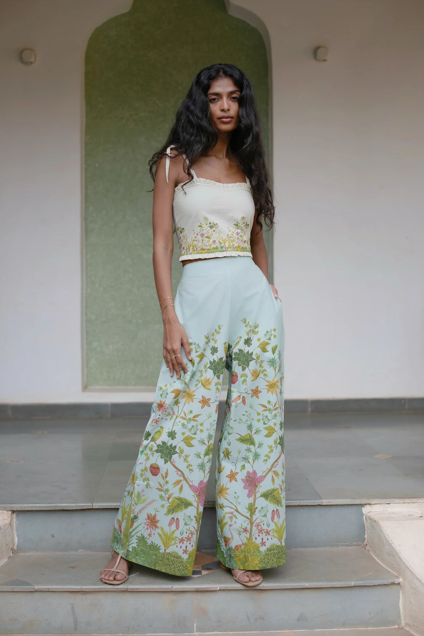 Front picture of Blue Floral Chintz inspired botanical print high-waisted wide-leg cotton trousers paired with off-white floral crop top with sweetheart neckline for styling — Amaya World handmade slow fashion