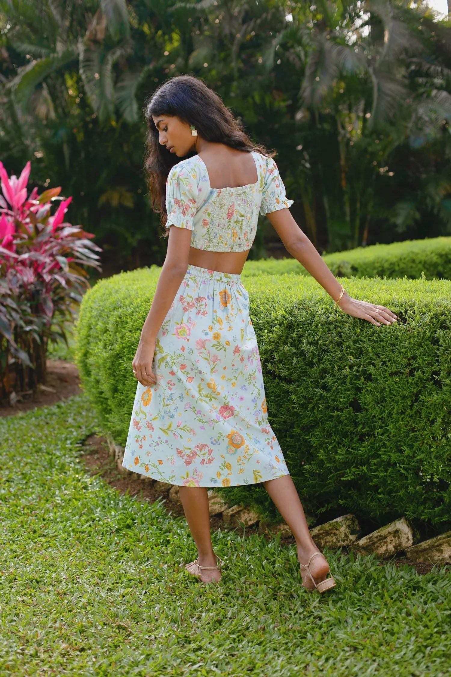 Back view of sky blue floral pencil skirt showing elasticated waistband and side zip — Amaya World