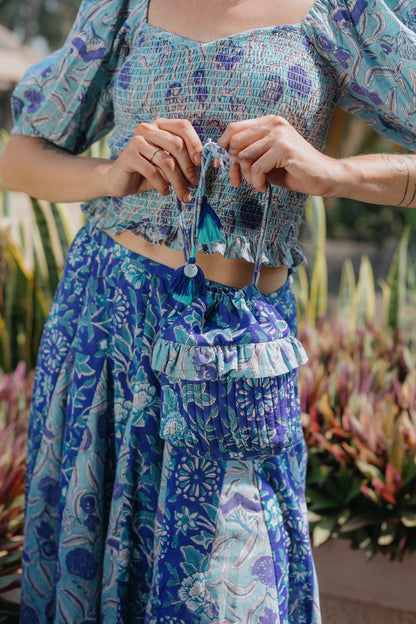 close up picture of model wearing indigo bucket bag