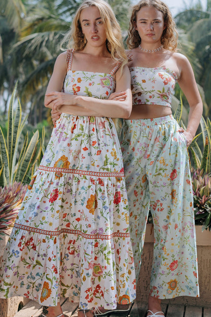 Front photo of white floral maxi dress and crop top and pant set
