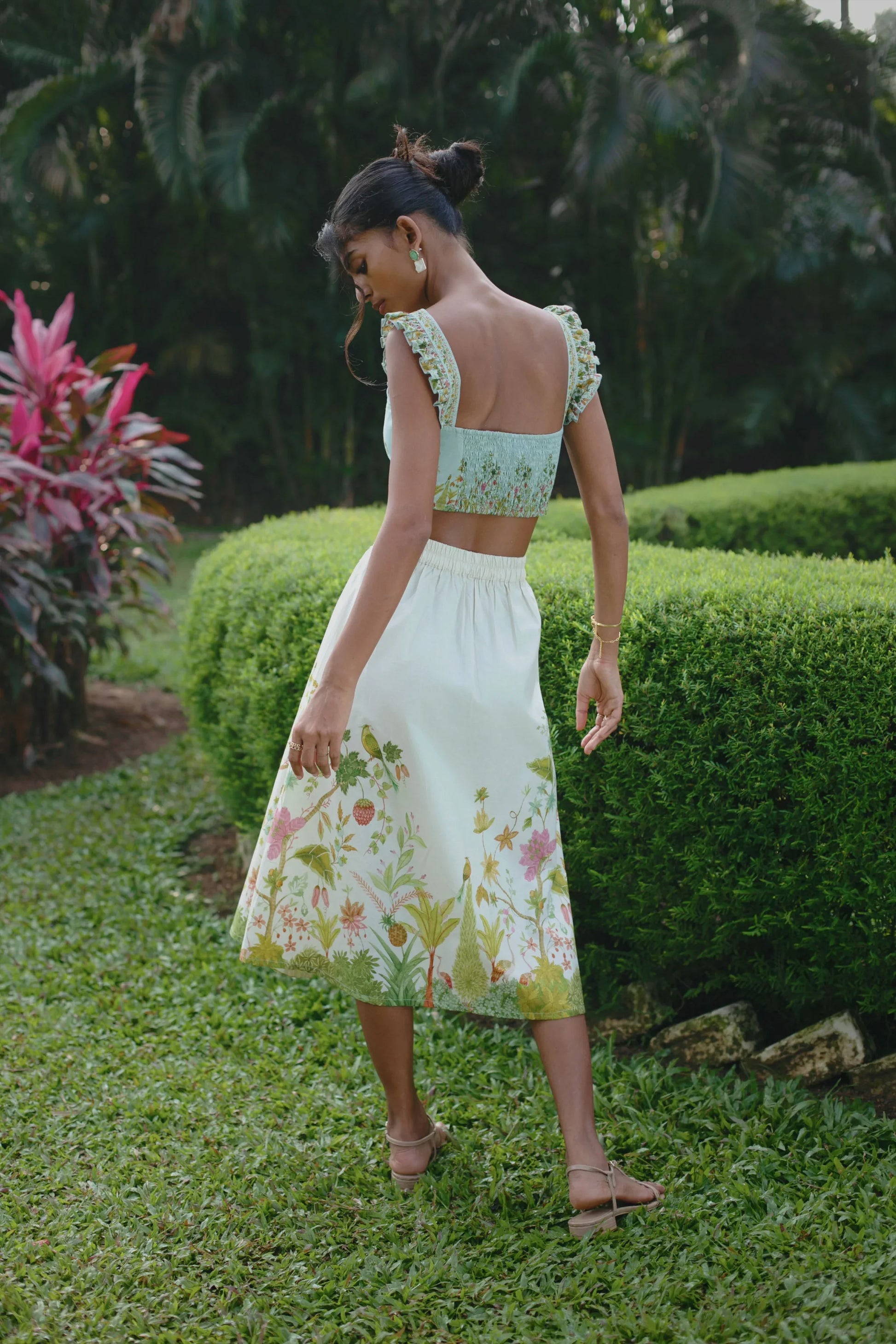 Back view of off-white Chintz midi skirt showing elasticated back and side zip styled with blue floral bralet crop top — Amaya World