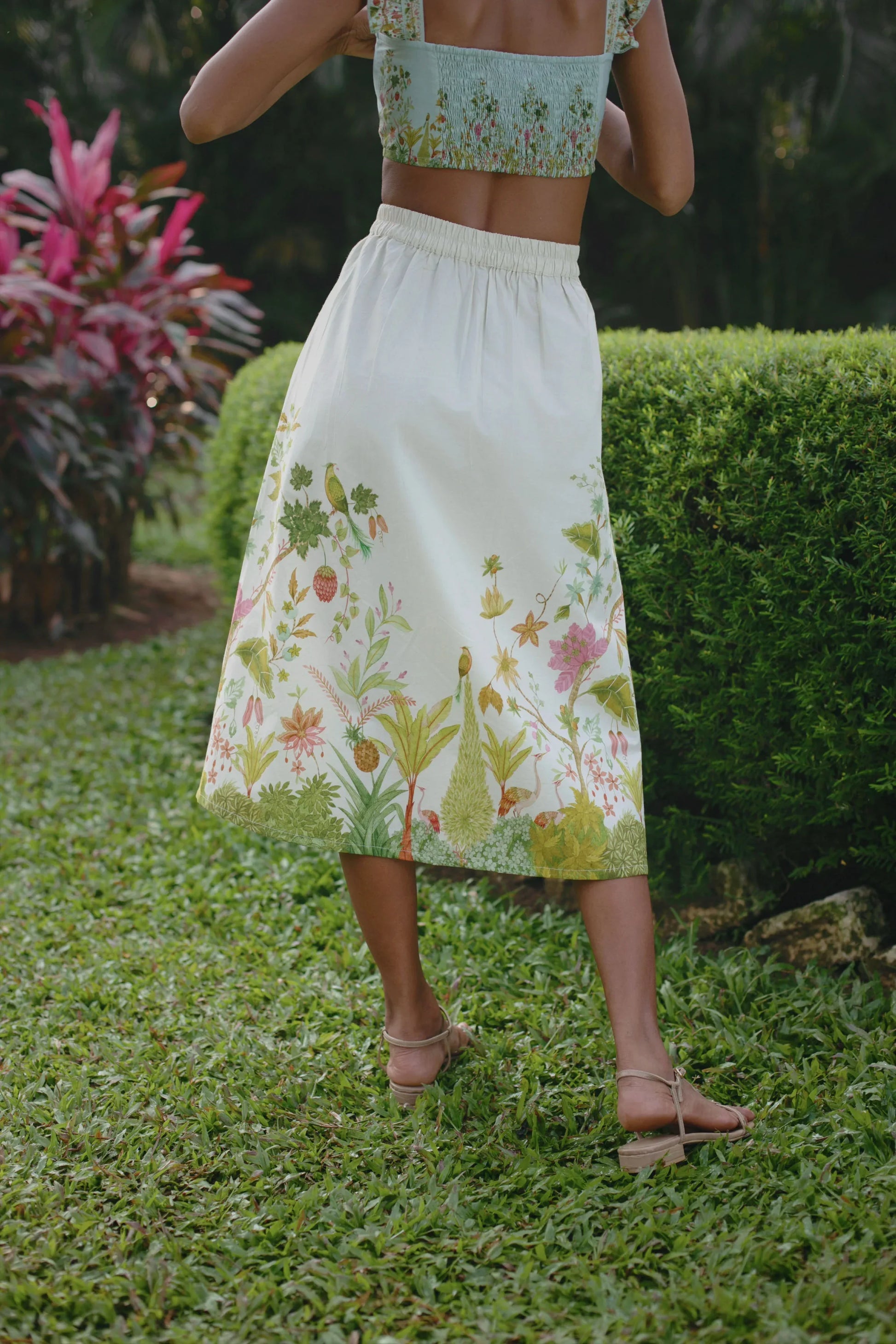 Close-up back view of off-white Chintz midi skirt showing elasticated back and side zip styled with blue floral bralet crop top — Amaya World
