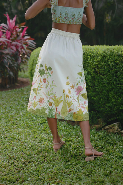 Close-up back view of off-white Chintz midi skirt showing elasticated back and side zip styled with blue floral bralet crop top — Amaya World