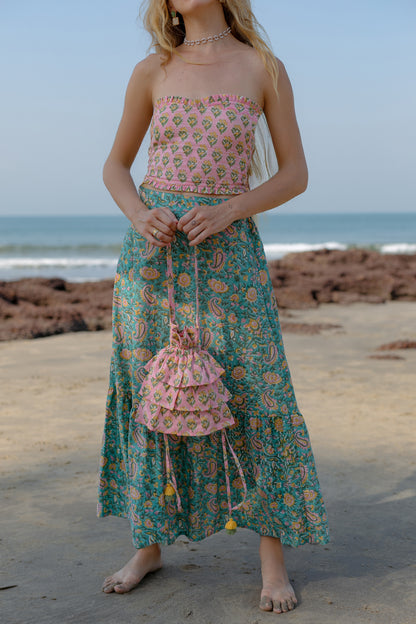 close up picture of model wearing pink frill bag with yellow flowers