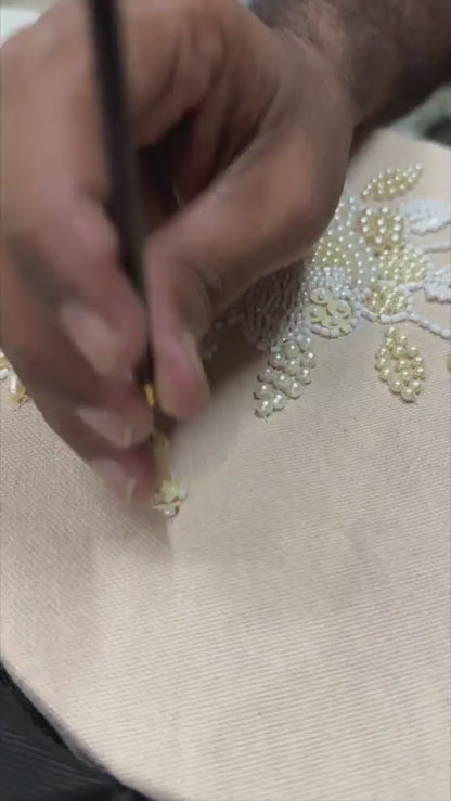 video of artist doing embroidery of off-white embroidered jacket
