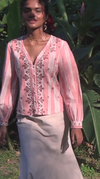 Video of pink embroidered blouse with puff sleeves
