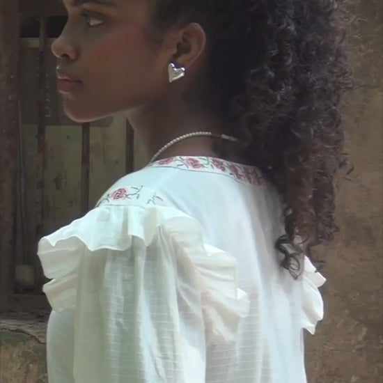 Video of white embrodiered button down top