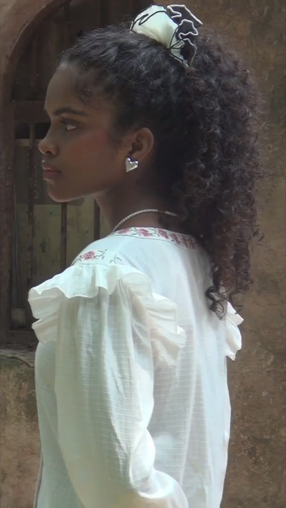 Video of white embrodiered button down top