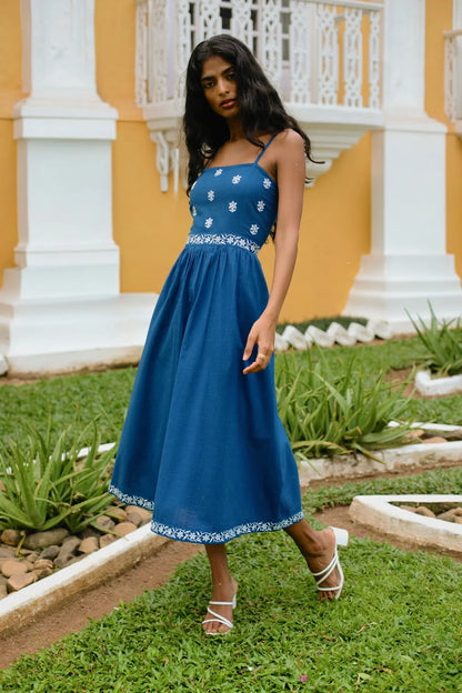 Side view of navy blue embroidered cotton midi dress styled for evening — Amaya World artisan slow fashion