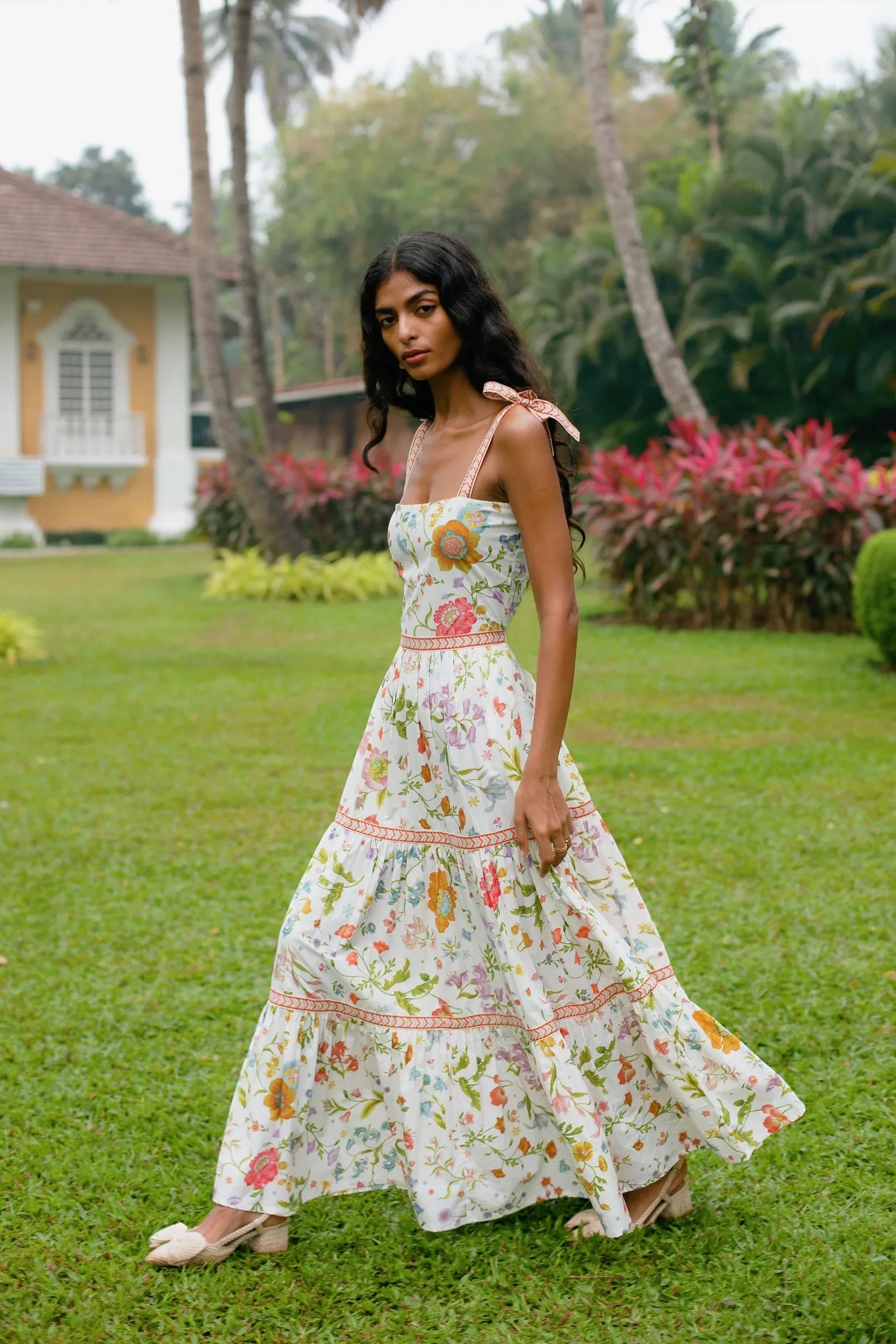 Side view of white floral tiered cotton maxi sundress with tie-up straps and  fit and flare silhouette — Amaya World