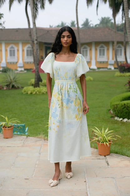 Front view of yellow floral cotton fit-and-flare midi dress with puff sleeves and square neckline — Amaya World