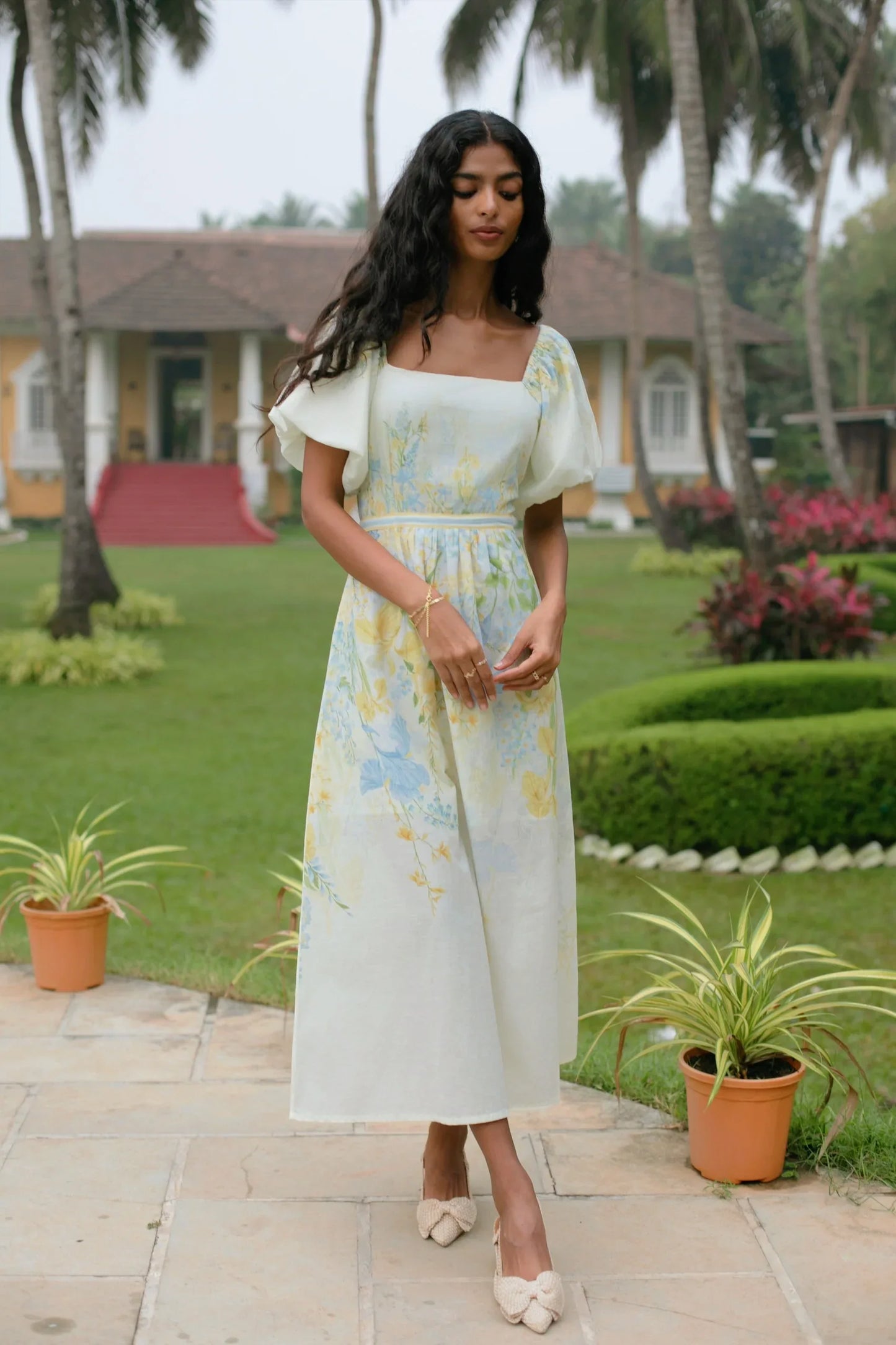 Sunkissed yellow floral cotton midi dress showing puff sleeves and square neckline detail perfect as birthday dress or vacation dress— Amaya World