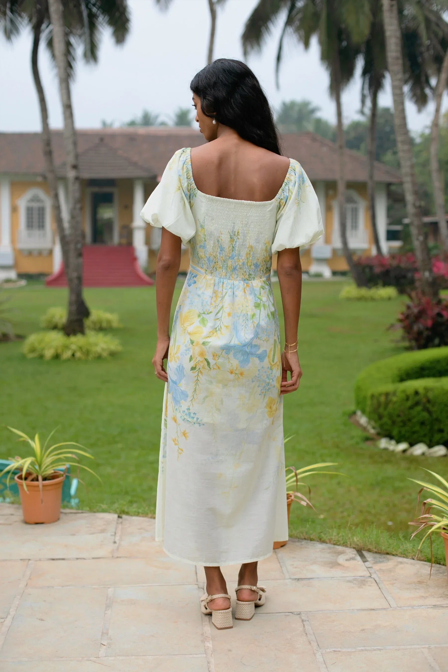 Back view of yellow floral puff sleeve cotton midi dress showing elasticated back — Amaya World