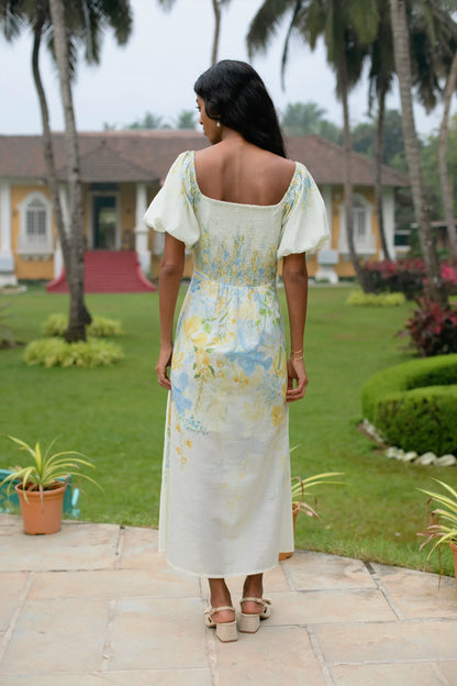 Back view of yellow floral puff sleeve cotton midi dress showing elasticated back — Amaya World